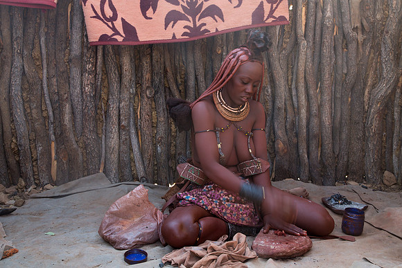 Himba Woman Making Red Body Paint 1